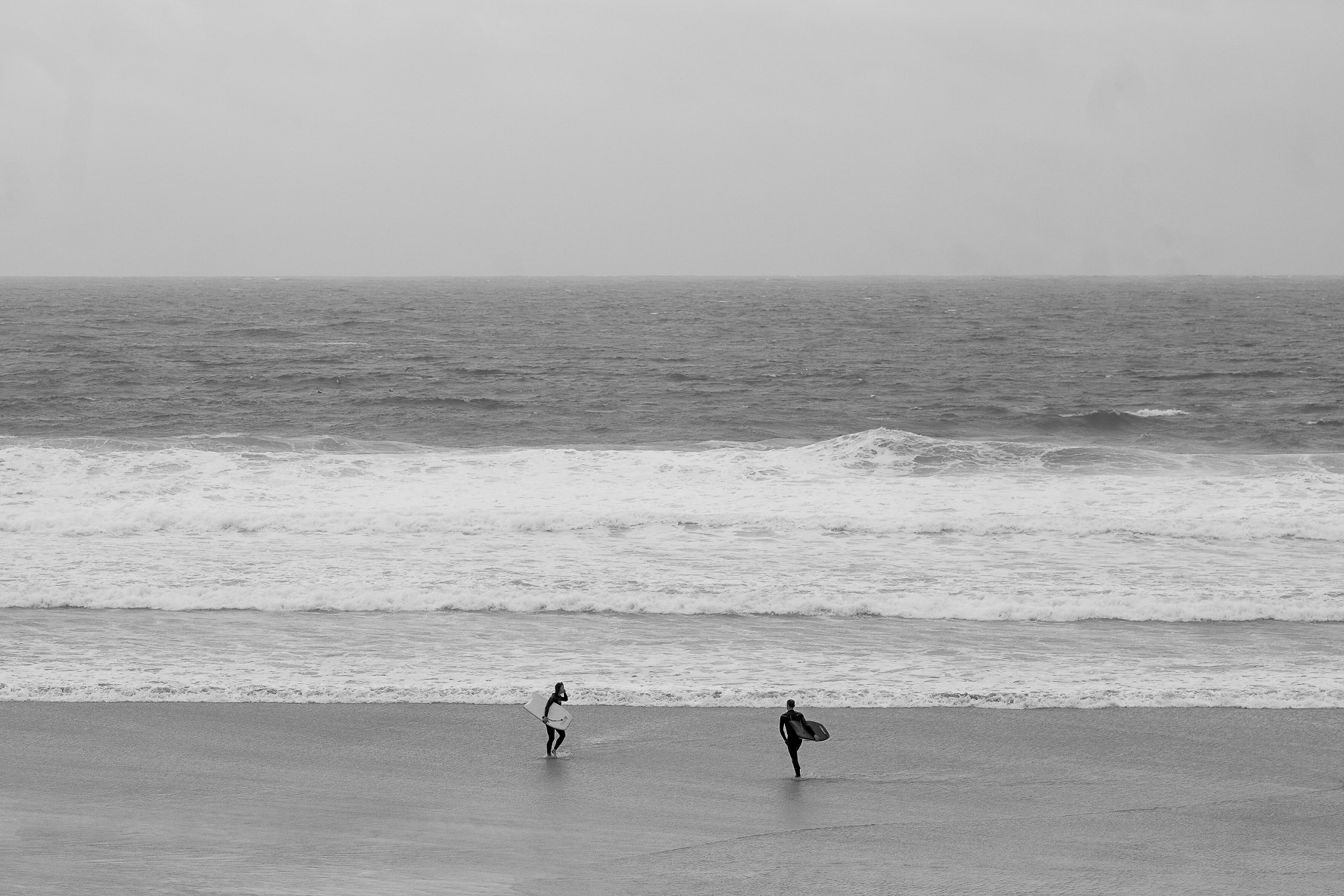 Ocean and beach scene with surfers
